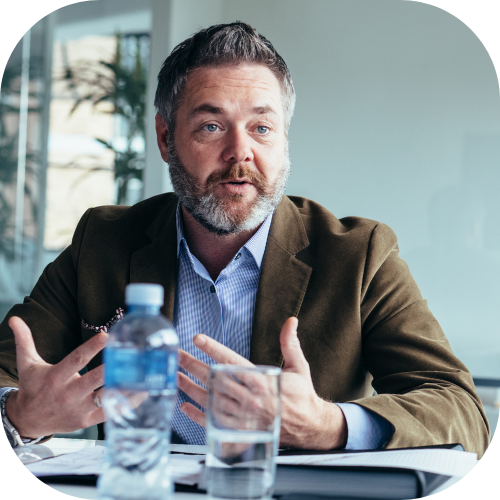 A man discussing finance ERP systems at a meeting table